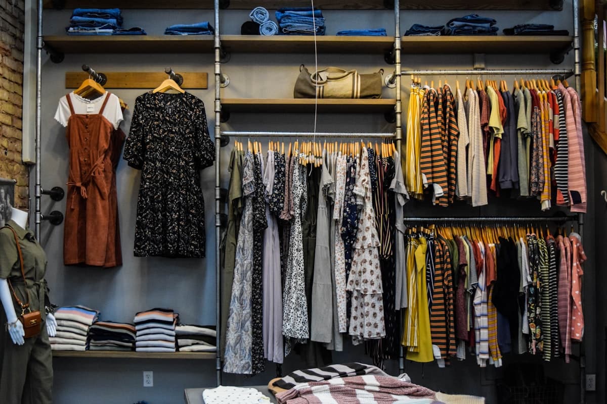 Freshly dry-cleaned suits and shirts on a rack at Debonair Cleaners